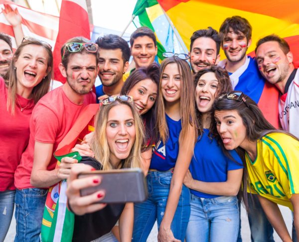 Happy fans supporters taking a selfie all together