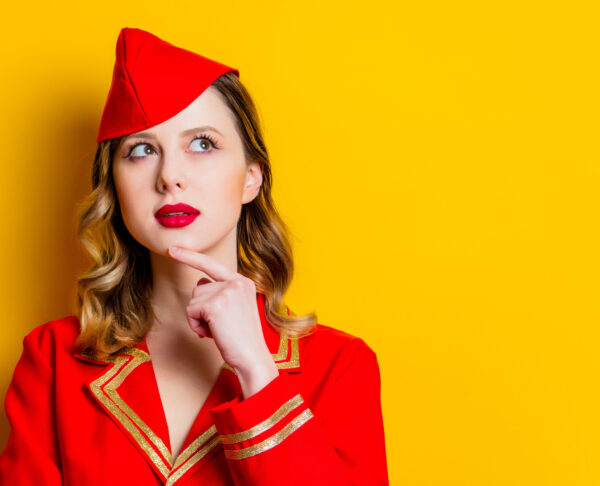 charming vintage stewardess wearing in red uniform